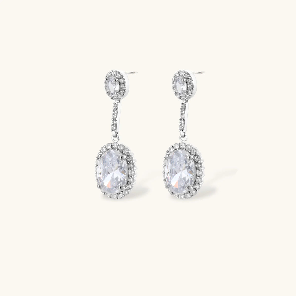 Elegant white gold plated jewelry set with oval cubic zirconia stones in halo settings, featuring Y-necklace and drop earrings.